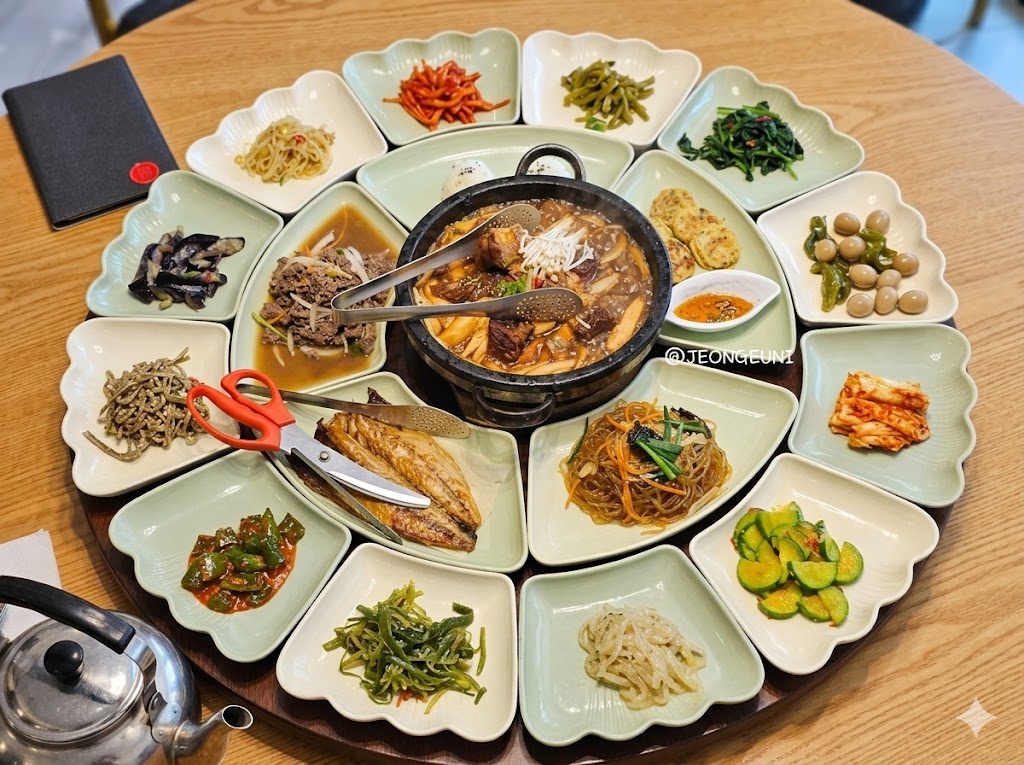 Traditional Korean hanjeongsik table spread with japchae and 20 side dishes